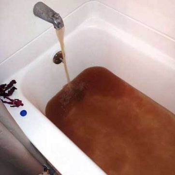 Rust brown water filling a tub in Bridge City, CA